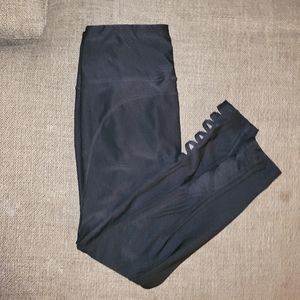 Black mid rise, mid calf athletic leggings with calf cutouts